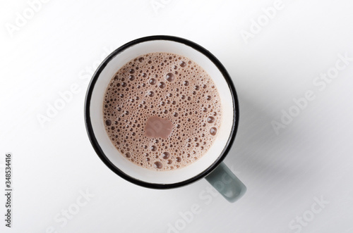Top view of rustic mug of hot chocolate drink on the white background
