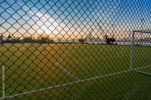 Digital composition of soccer field and blue sky