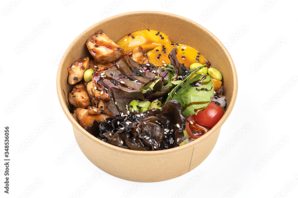 Poke bowl with chicken and vegetables on the white table. Poke bowl with chicken and vegetables on the white table.