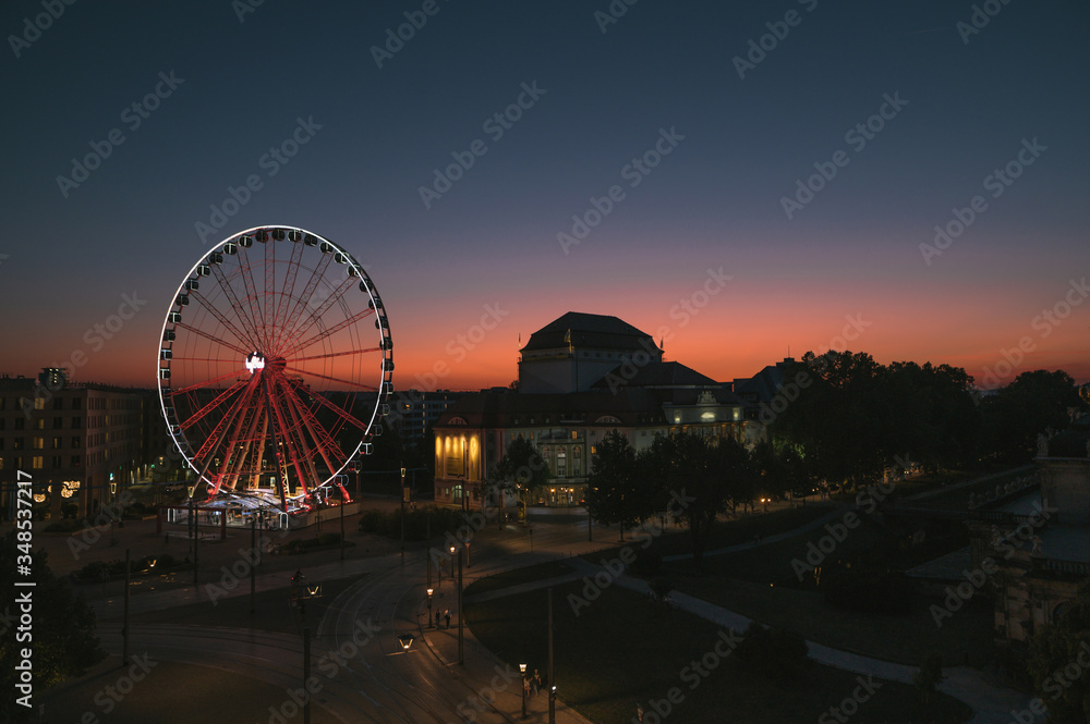 Evening Dresden. View of the ferris wheel and deserted evening streets and tram tracks at sunset. Tourism in Dresden. Night landscape Dresden, German