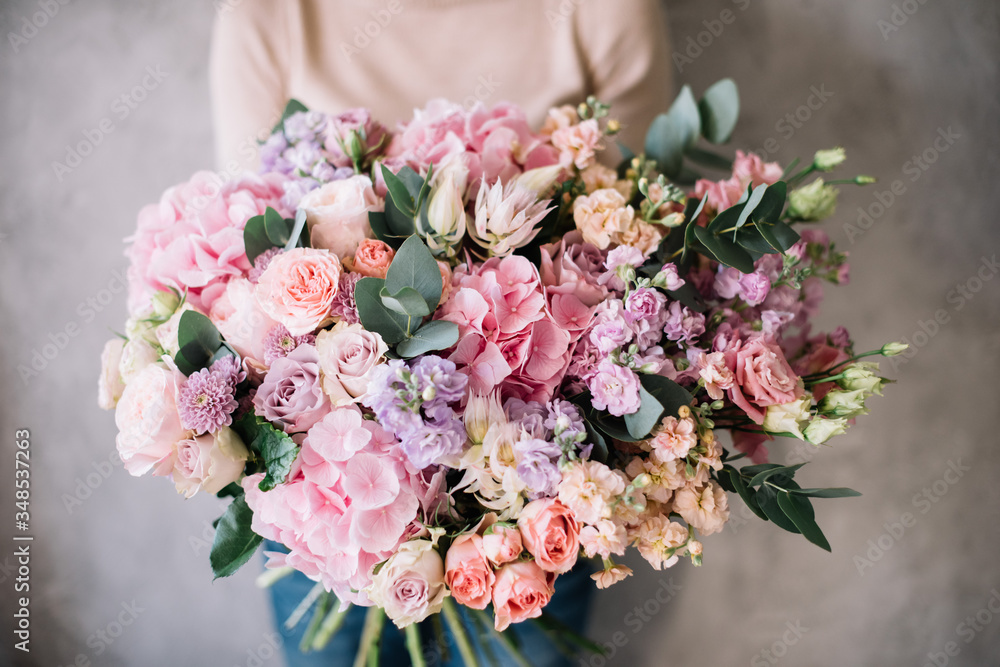 custom made wallpaper toronto digitalVery nice young woman holding big beautiful blossoming bouquet of fresh hydrangea, roses, eustoma, matthiola, eucalyptus flowers in tender pink and pastel purple colors on the grey wall background