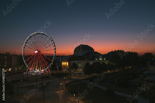 Evening Dresden. View of the ferris wheel and deserted evening streets and tram tracks at sunset. Tourism in Dresden. Night landscape Dresden, German