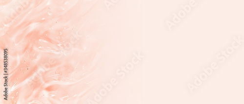 Beauty serum background. Clear liquid gel splash. Transparent pink color cosmetic cream texture. Skincare product banner