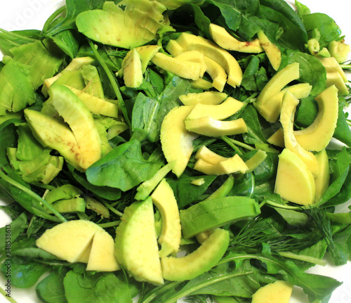 Raw vegan food as background. Salad of greens, avocado, arugula, spinach, close-up