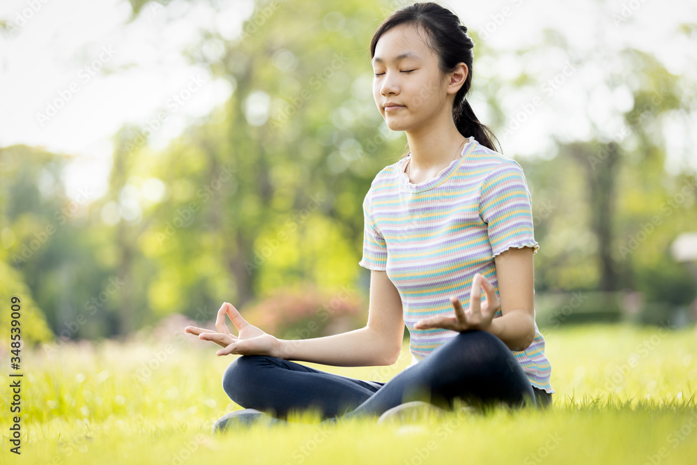 Happy woman meditating on the grass at park,asian child girl practicing yoga meditation in nature outdoor,enjoy breathing fresh air after Covid-19 quarantine,after lockdown for coronavirus outbreak Happy woman meditating on the grass at park,asian child girl practicing yoga meditation in nature outdoor,enjoy breathing fresh air after Covid-19 quarantine,after lockdown for coronavirus outbreak