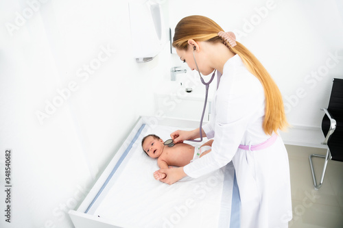 Fototapeta Naklejka Na Ścianę i Meble -  medicine, healthcare and pediatrics concept - female pediatrician or neuropathist doctor or nurse checking baby patient's at clinic or hospital
