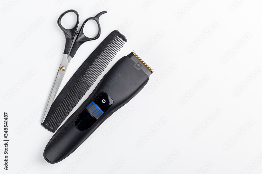 hair clipper, scissors and comb on a white background hair clipper, scissors and comb on a white background