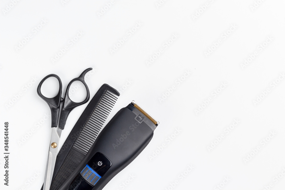hair clipper, scissors and comb on a white background hair clipper, scissors and comb on a white background