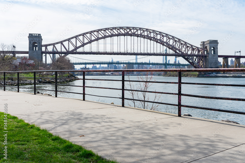 Walkway along the East River with the Hell Gate Bridge in the Background in Astoria Queens New York