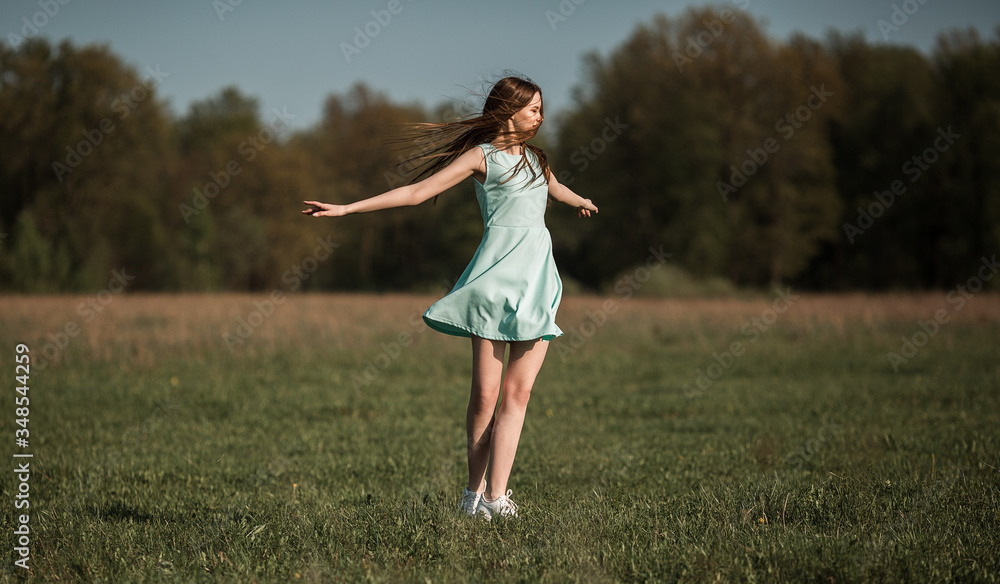 Girl on the field enjoys the spring wind. Fashionable photo. High quality photo. Girl on the field enjoys the spring wind. Fashionable photo. High quality photo.