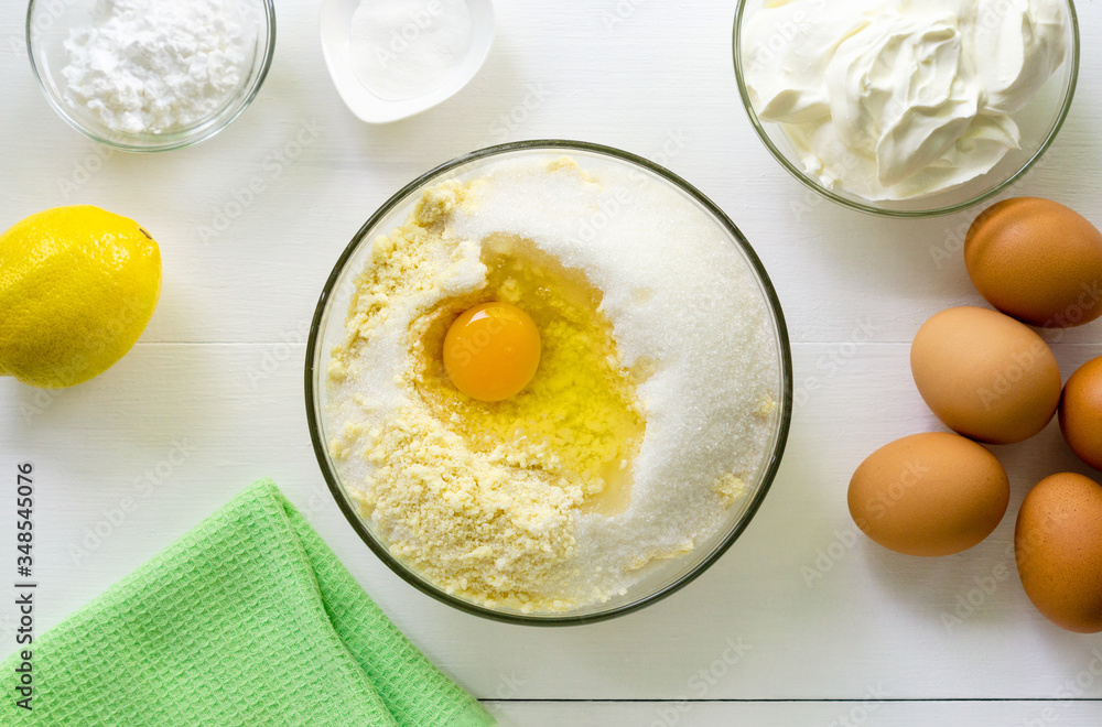 Step by step recipe of cheesecake. Flour mixture with egg and sugar in a bowl Step by step recipe of cheesecake. Flour mixture with egg and sugar in a bowl