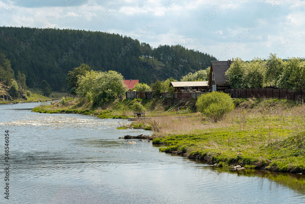Rural landscape with river and house