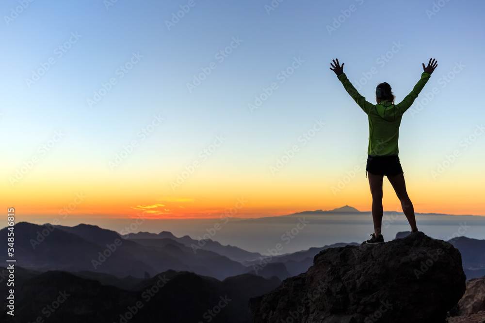 Woman climber success silhouette in mountains, achievement inspiration