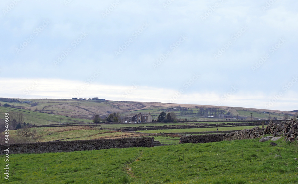 west yorkshire landscape with fields surrounded by stone walls with farmhouses and rolling moorland hills in the distance near colden west yorkshire landscape with fields surrounded by stone walls with farmhouses and rolling moorland hills in the distance near colden