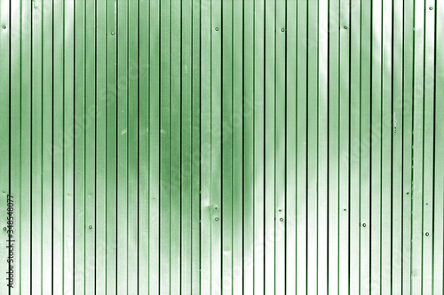Metal list wall texture of fence in green tone.