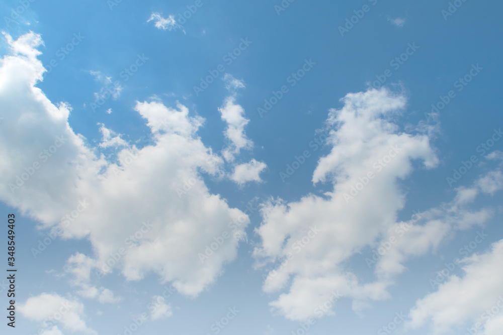 Tropical summer bright blue sky background with white puffy fluffy cumulus clouds & cotton candy cloudscape in beautiful warm weather & sunny morning sunlight on daylight horizon at sunshine day Tropical summer bright blue sky background with white puffy fluffy cumulus clouds & cotton candy cloudscape in beautiful warm weather & sunny morning sunlight on daylight horizon at sunshine day