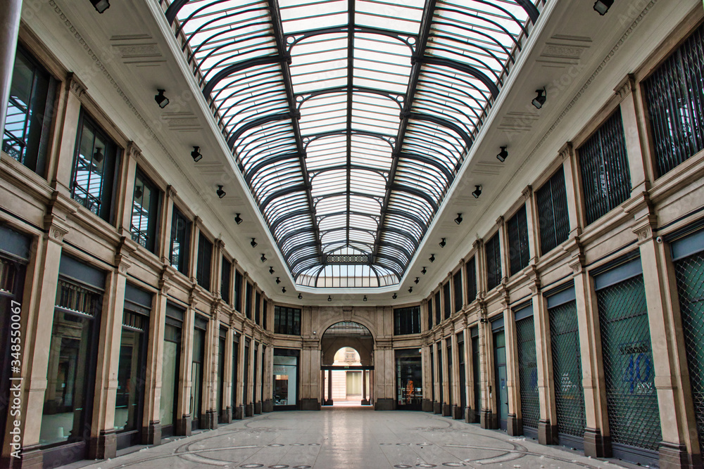 Glass and iron roof of an empty covered passage in Milan