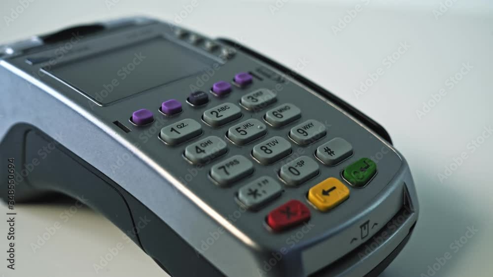 Customer paying with NFC technology by mobile phone on POS terminal Customer paying with NFC technology by mobile phone on POS terminal