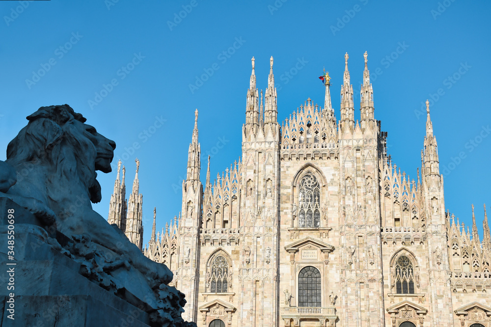 The golden sunshine is reflecting on the front of the magnificent Duomo di Milano or Milan Cathedral after Italy eases coronavirus restrictions