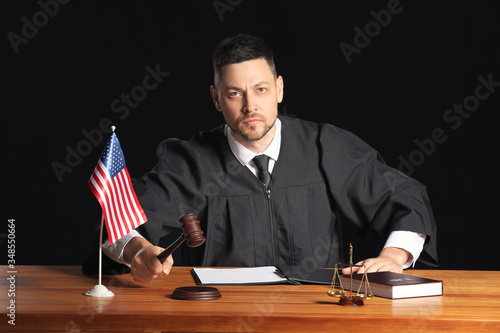 Strict male judge at table ...