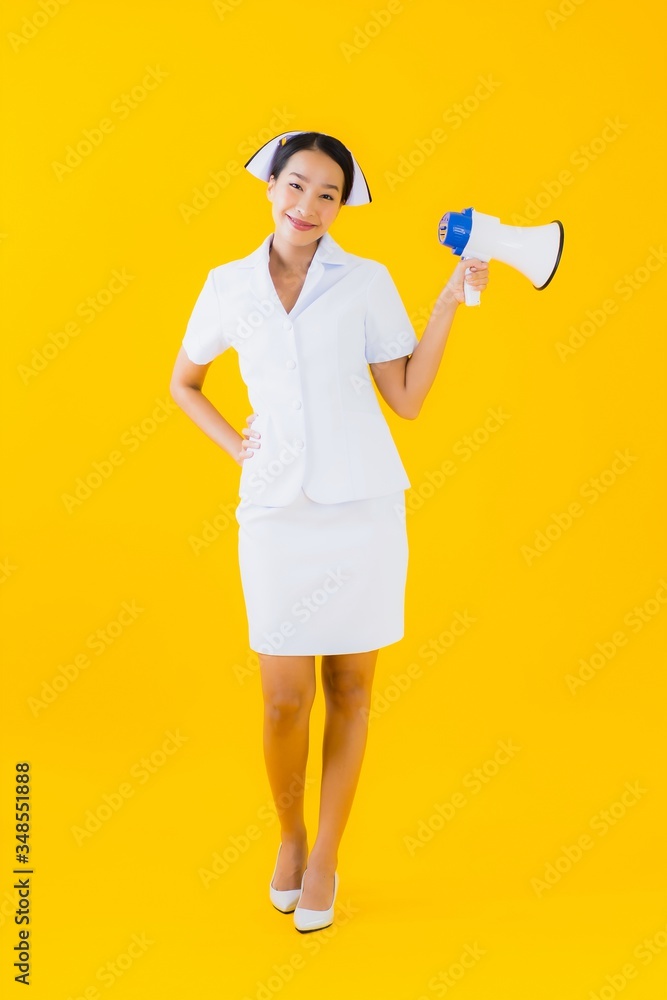 Portrait beautiful young asian woman thai nurse with megaphone for communicate Portrait beautiful young asian woman thai nurse with megaphone for communicate