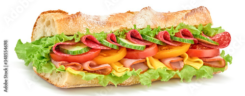 Submarine sandwich with ham, cheese, salami, tomato, lettuce salad, cucumber isolated on white. Homemade baguette sandwich with vegetables. Large sub sandwich closeup, banner