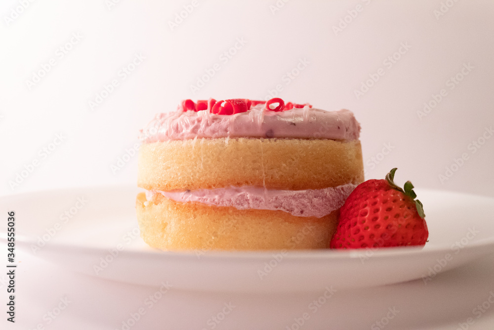 mini cake with strawberry on white plate