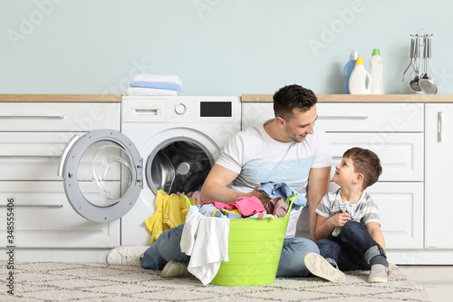 Man and his little son doin...