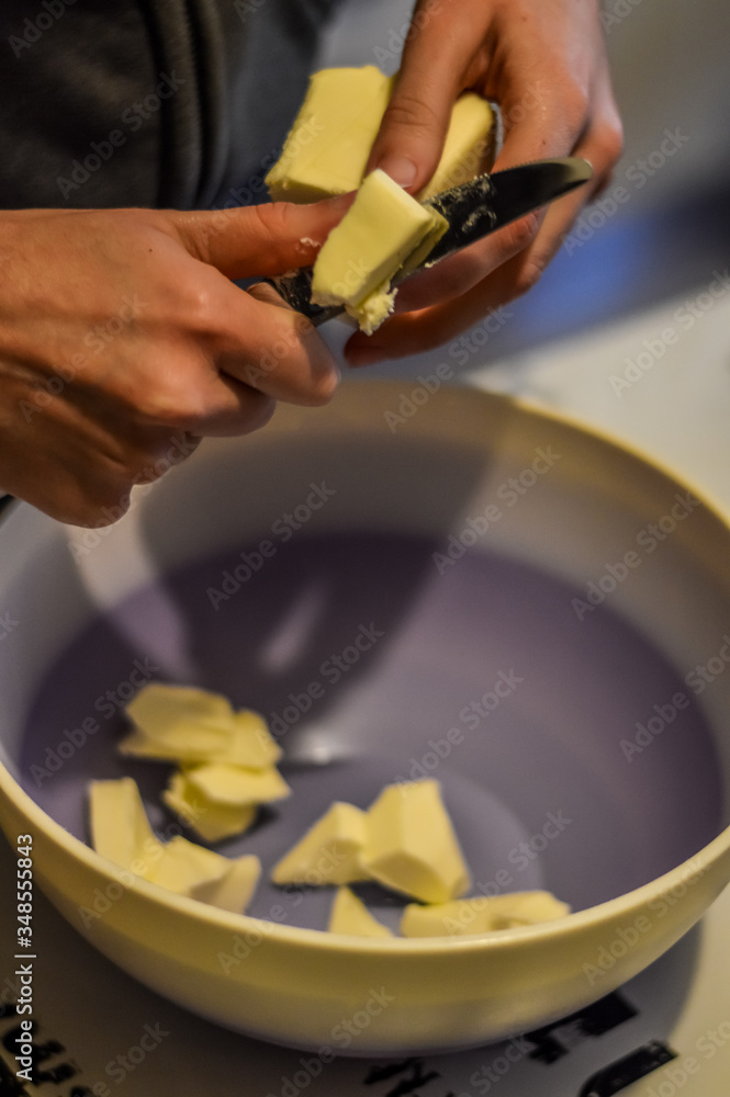 woman hands cutting butter to prepare cookies dough close up woman hands cutting butter to prepare cookies dough close up