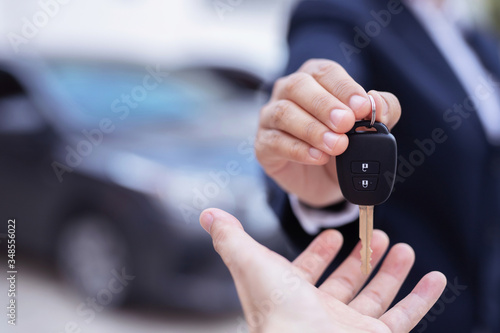 Salesman is carrying the car keys