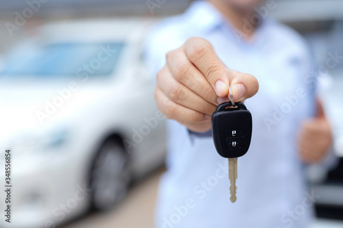 Salesman is carrying the car keys