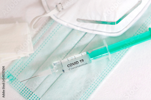 Close-up of syringe with vaccine against corona and mouth nose mask