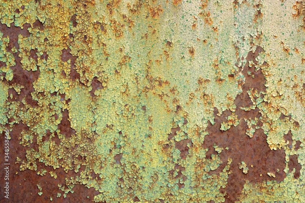 Multicolored background, rusty metal surface with green paint flaking and cracking texture. rusty and damaged metal