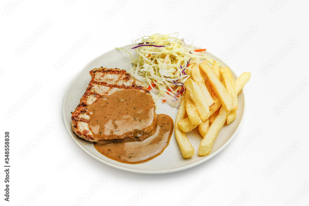 Grill pork steak with creamy pepper sauce, served with Vegetable salads and French fries on white background