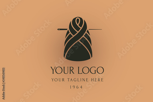 Braid hair logo. doll sewn of ball of wool with a needle