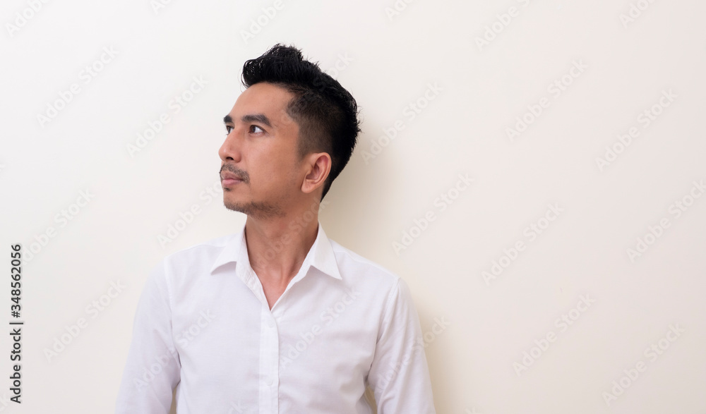 Young Asian man isolated on white background looking sideways Young Asian man isolated on white background looking sideways