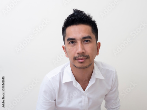 Portrait of smiling young man wearing white  shirt © rufous