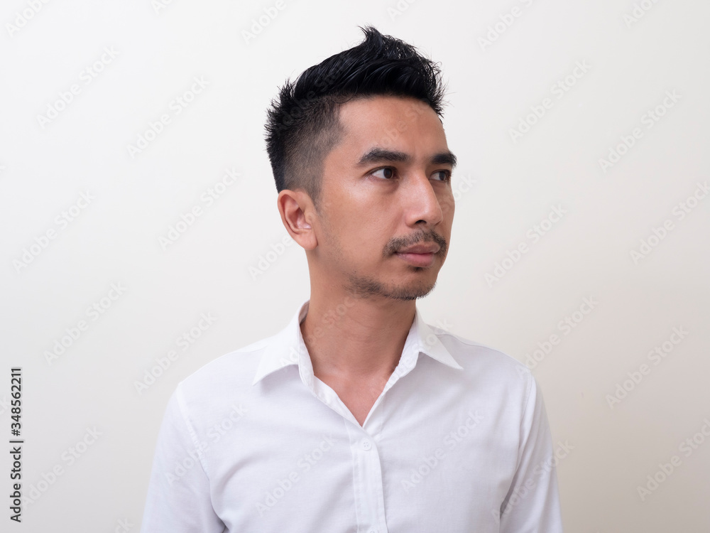 Young Asian man isolated on white background looking sideways Young Asian man isolated on white background looking sideways