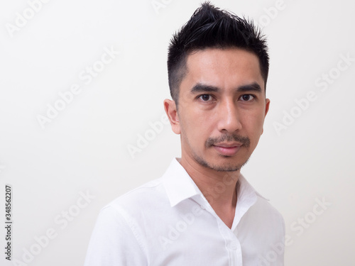 Portrait of smiling young man wearing white shirt