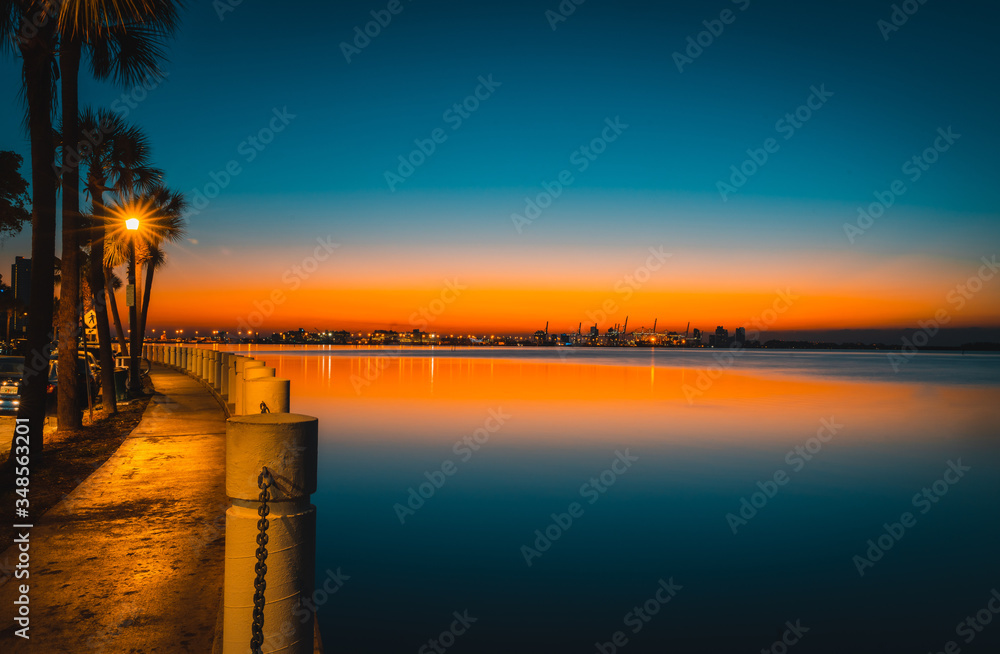 Fototapeta premium dawn water sea bay miami florida brickell sky clouds lighting beautiful impressions calm nature coast summer horizon orange blue