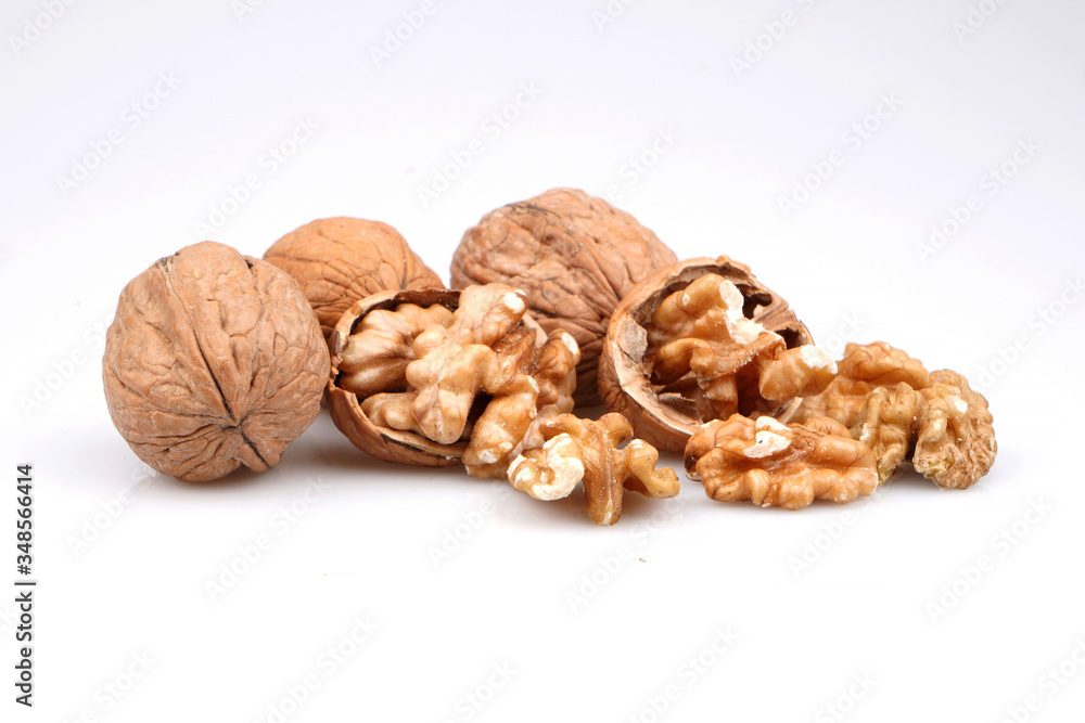 Organic Delicious whole and broken walnuts, isolated on white background Organic Delicious whole and broken walnuts, isolated on white background