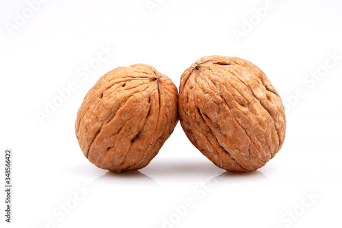 Delicious whole organic two walnuts, isolated on white background