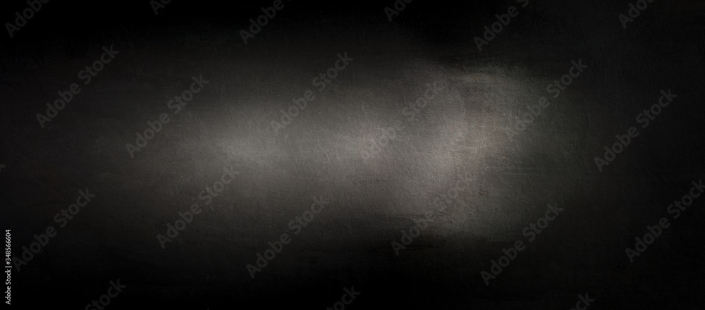 Fototapeta premium Panoramic light falling on black wood texture. Close up panorama of a wooden chipboard surface. 