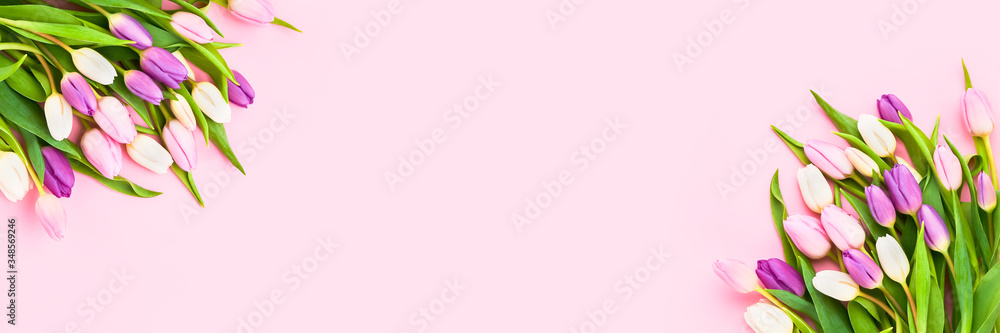 Pink Holiday banner. Bouquet of pink tulips on pink background. Mother's day, Valentines Day, Birthday celebration concept. Copy space, top view Pink Holiday banner. Bouquet of pink tulips on pink background. Mother's day, Valentines Day, Birthday celebration concept. Copy space, top view