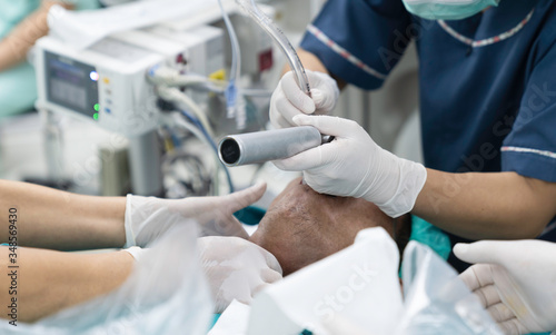 doctor apply laryngoscope to intubate endotracheal tube
