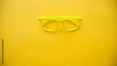 yellow glasses on a yellow background