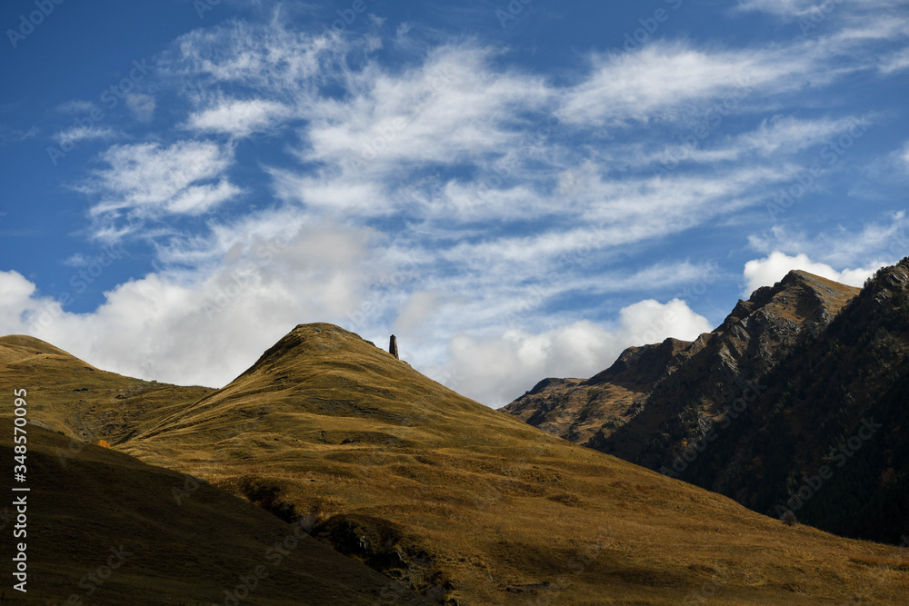 Medieval tower against a mountain landscape in Tusheti region