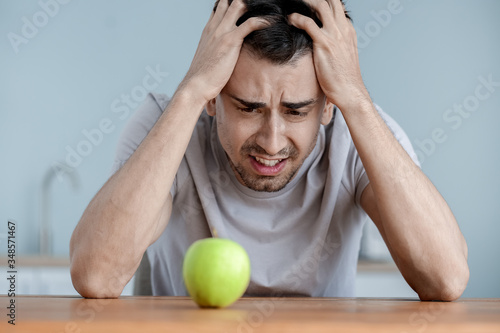 Young man suffering from an...