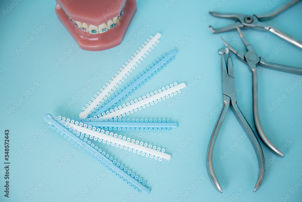 Metal braces for teeth and tools for correction of brace systems