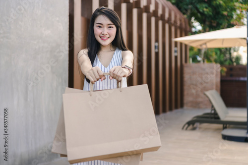 Happy Asian woman with shopping bags enjoying in shopping.